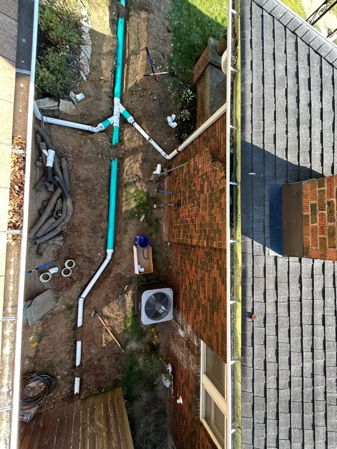 Buried downspout drainage with PVC pipe being installed in a yard