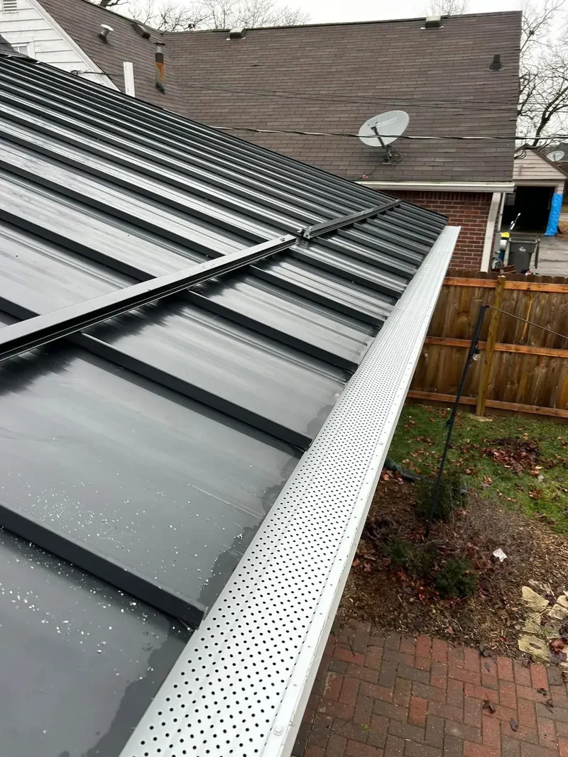 Snow bars installed above seamless gutters with gutter guards