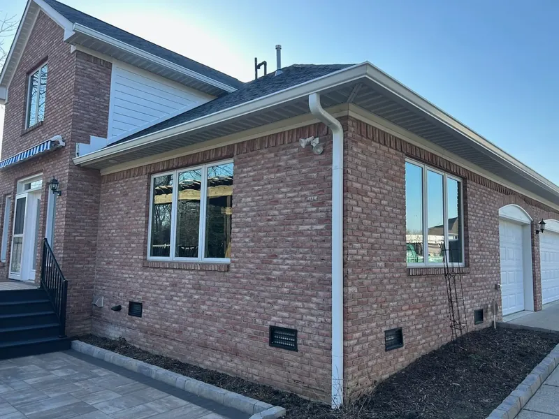 New 6-inch white seamless gutters and downspouts on an Indianapolis home